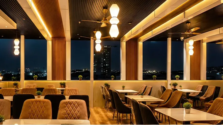 Rooftop restaurant dining tables and evening view at Erleen Hotel